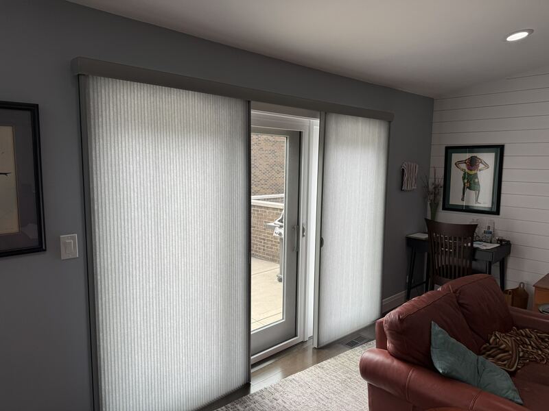 The same installation seen wider - the door panel and the adjacent window read as one continuous treatment.